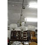 Ceiling light fittings: one with glass column, two metal ones with foliate decoration and a modern