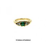 Three stone emerald and diamond ring, central emerald cut emerald with a round brilliant cut diamond