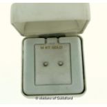 *Pair of single stone diamond ear studs, mounted in white metal stamped 14ct, estimated total