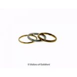 Two 22ct gold wedding bands, weight together 4.4 grams, ring sizes M and M½, together with a white