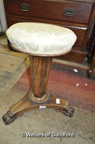 A Victorian rosewood adjustable piano stool with overstuffed seat on hexagonal column terminating in