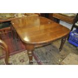 A late Victorian oak extending dining table with two extra leaves, raised on turned legs, 107 x