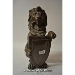 A small (and extremely heavy) cast iron model of a seated lion holding a shield, 36cm.