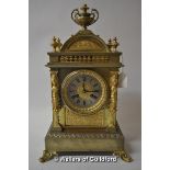 A gilt metal mantel clock with urn surmount and caryatid supports, the silvered dial with two