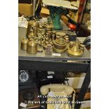 A quantity of mostly brass weights including bell weights, a set of stacking weights, different