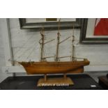 A clinker built three masted sailing boat on stand, 71cm long.