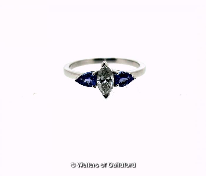 Tanzanite and diamond ring, central marquise cut diamond, with a pear cut tanzanite set to either