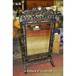 A Chinese hardwood firescreen with adjustable mirrored panel, the cresting rail carved with dragons,