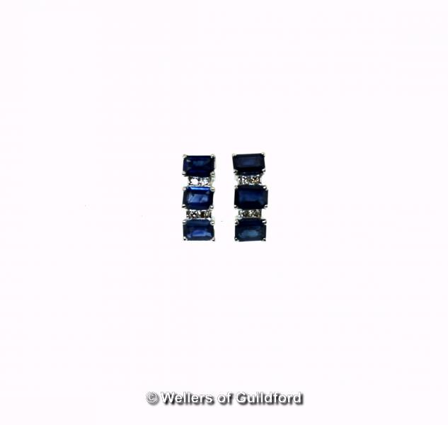 Sapphire and diamond earrings, each earring consisting of three rectangular step cut sapphires and