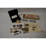 Two pairs of ladies garters (as new); a small quantity of badges and a battery operated miniature