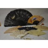 An 18th Century fan, the black lace leaf with small painted scene of reclining woman with cherub and