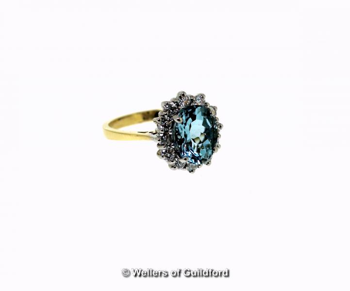 *Aquamarine and diamond cluster ring, oval cut aquamarine, weighing an estimated 2.50cts, with a