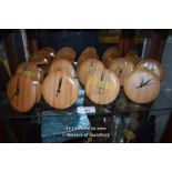 SHELF OF NINE BRAND NEW SMALL WOODEN WALL CLOCKS