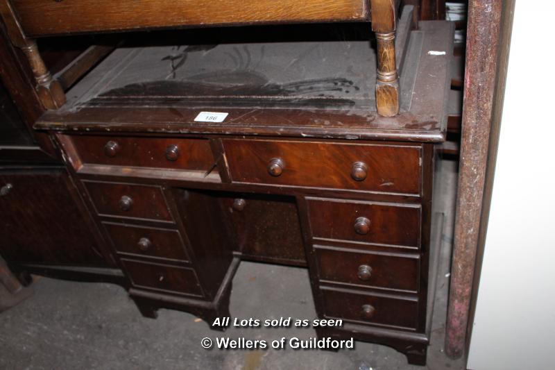 SMALL OAK PARTNERS DESK WITH BROWN LEATHER INSERT COMPRISING EIGHT DRAWERS AND ONE CENTRAL CUPBOARD,