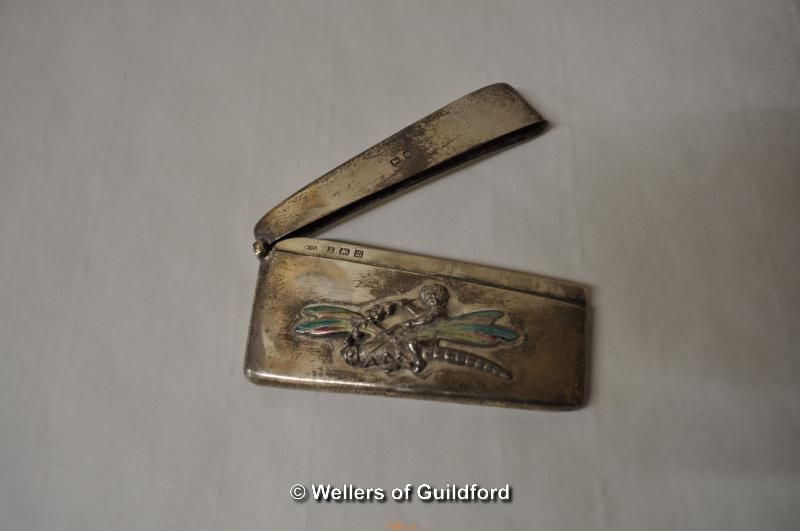 A curved silver card case with applied motif of cherub riding a dragonfly with enamelled wings, - Image 2 of 3
