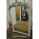 A grey painted wall mirror, the arched top moulded with flowers, Nordic Style London label, 138 x