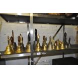 A large quantity of hand bells, mostly in brass with some examples in other metals and one wall