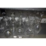 A group of sixteen decanters or carafes.