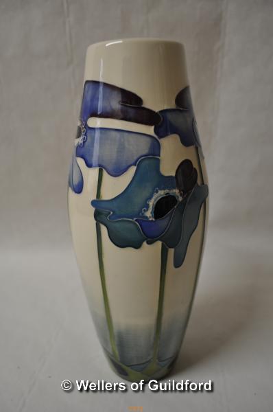 Moorcroft baluster vase with tall blue flowers on a white ground, 21cm.