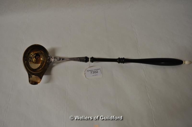 A white metal punch ladle, the turned wooden handle with ivory knop, the bowl stamped 830, 39cm.