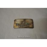 A curved silver card case with applied motif of cherub riding a dragonfly with enamelled wings,