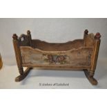A small Continental cradle with painted decoration dated 1872, 54cm long.