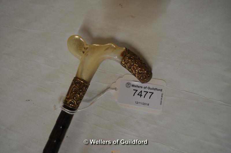 A brown parasol with bamboo shaft, the mother-of-pearl handle mounted with gilt metal, 86cm. - Image 2 of 2