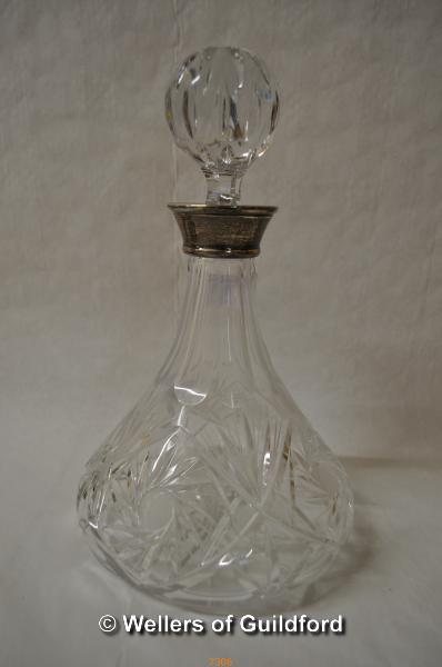 A cut glass ship's decanter with silver collar, Mappin & Webb, Birmingham 1976.