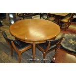 A G-Plan circular teak table, extending to oval; a set of four dining chairs upholstered in black