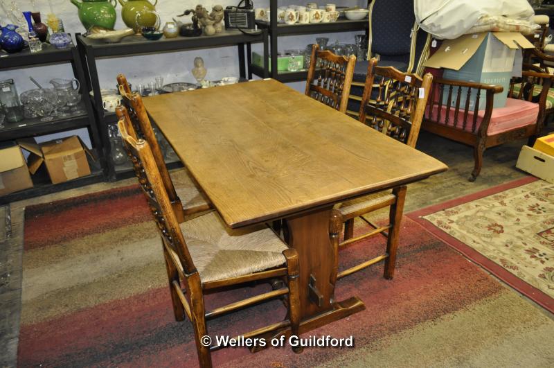 A small oak refectory table, 138 x 74cm, and set of four spindle back oak chairs with rush seats.
