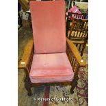 An Edwardian oak adjustable armchair with pink cushions.
