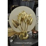 A decorative lamp modelled as a bunch of lillies with cream ceramic flowers and golden metal leaves,