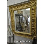 An imposing Victorian mirror, the stepped rectangular frame moulded with figures, shells, birds