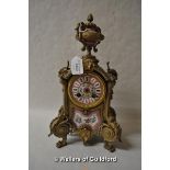 A Victorian gilt metal mantel clock with pink porcelain panels, with urn finial, the pink enamel