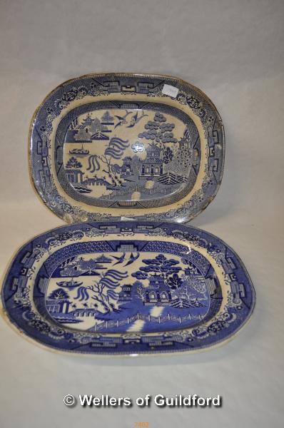 A near pair of Willow pattern blue and white meat plates.