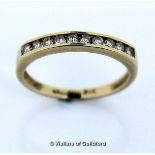 Diamond set half eternity ring, round brilliant cut diamonds channel set in yellow metal stamped