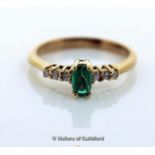 Emerald and diamond ring, oval cut emerald with three round brilliant cut diamonds set to either