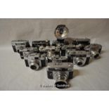Fourteen cameras with lenses, and an additional flash; Camera bodies include - Agfa, Argus and