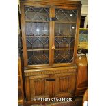 An oak bookcase with astragal glazed doors over linenfold panelled doors, 191cm x 92cm