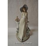 Lladro figure of a lady wearing a large hat leaning on a balustrade, 35cm.