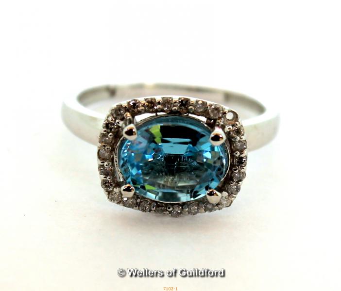 *2ct oval blue topaz and natural diamond Halo ring, 10K white gold (Lot subject to VAT)