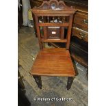 An Edwardian walnut hall chair of typical design.