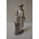 Lladro figure of a lady standing beside an urn of flowers, 35cm.