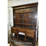 An early 19th Century oak dresser with triple delft rack over an arrangement of five small drawers