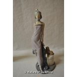 Lladro figure of a 1920's style lady with a dog seated on a chair, 33cm.