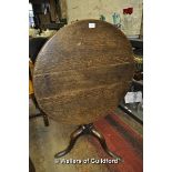 An oak circular tilt top tripod table, 74cm diameter.