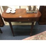 A mahogany hinged top games table.