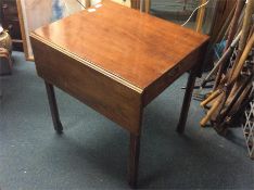 A mahogany single drawer drop flap table.