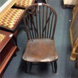 An Antique oak stick back chair.