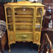 An unusual yellow painted glazed cabinet.